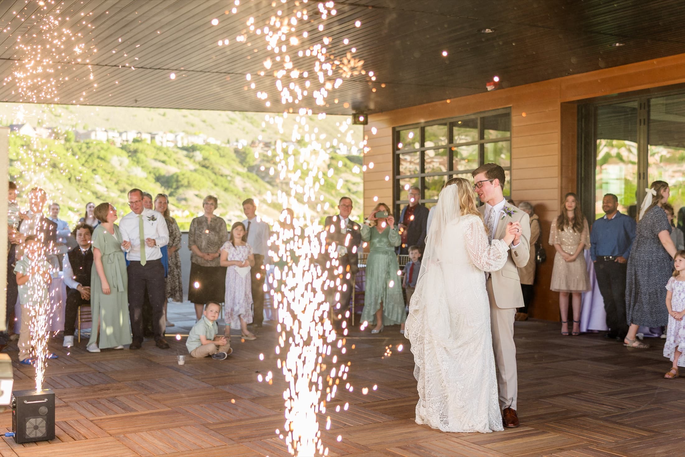 Newlyweds sharing their first dance between cold spark fountains