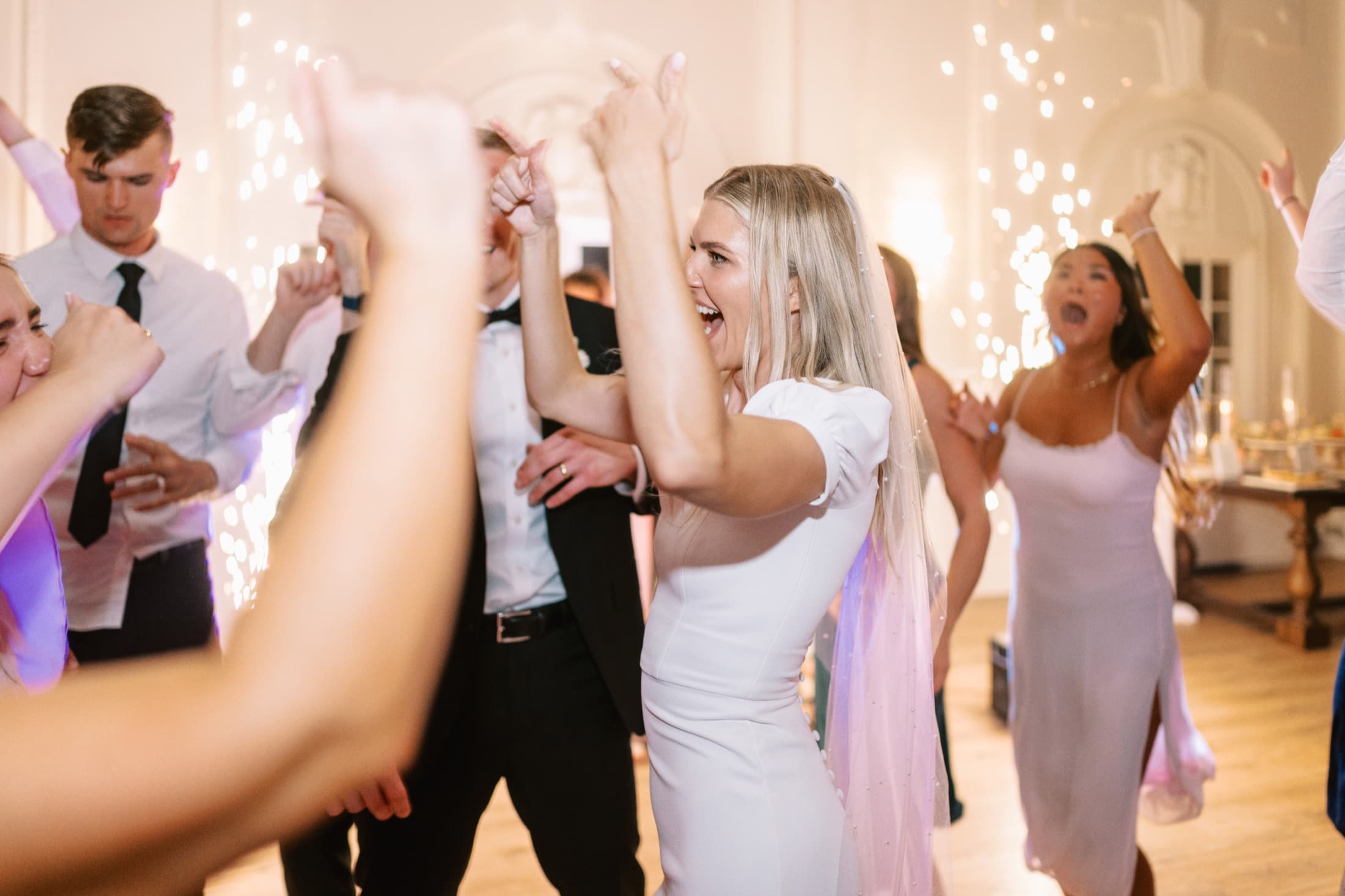 Wedding guests dancing with colorful party sunglasses