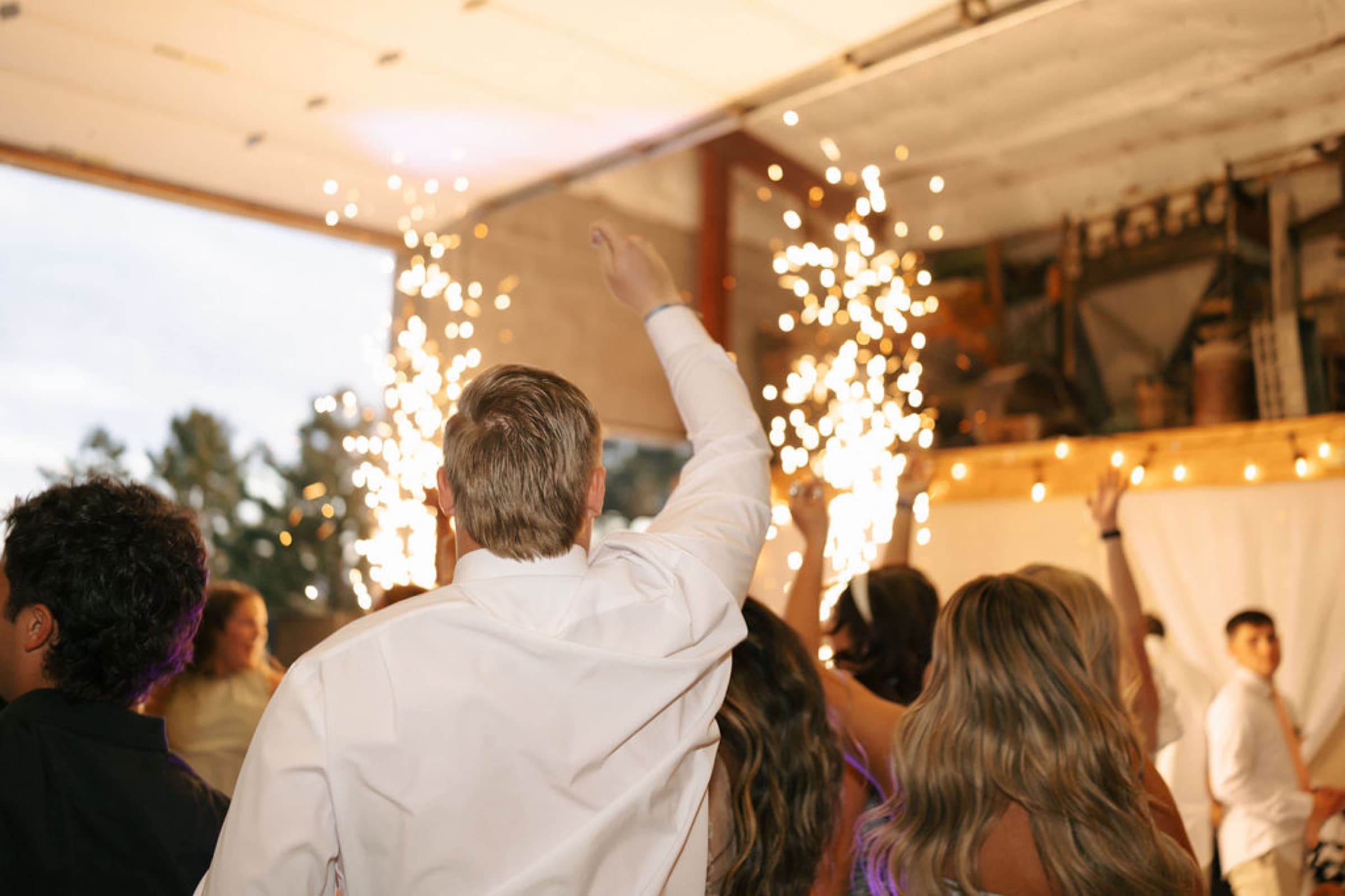 Newlyweds celebrating with cold sparks at their reception